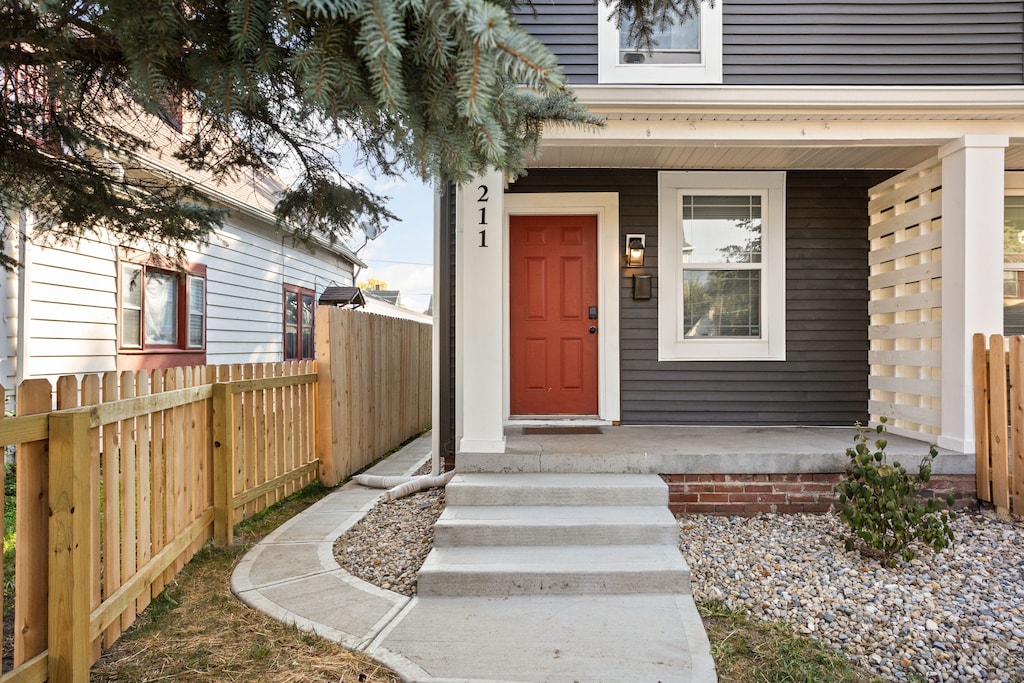 Charming Entrance: Bright red door welcomes you to unforgettable Indianapolis adventures!