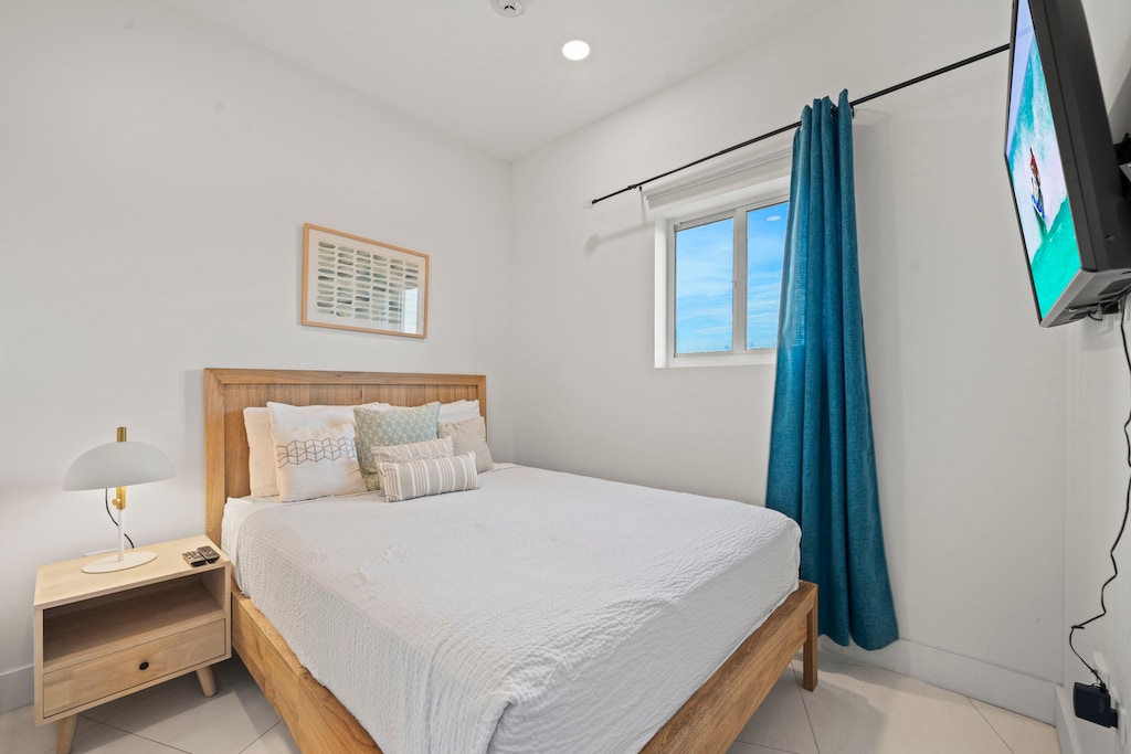Comfort in this stylish bedroom with a dreamy queen sized bed - Thoughtfully designed with soft tones, plush pillows, and serene vibe, perfect for relaxation - Whether it's a restful night or a lazy morning, this space is your personal retreat