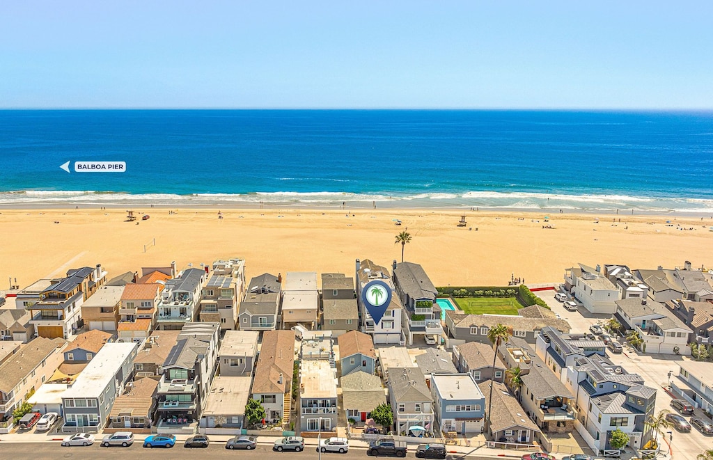 Aerial view highlighting the prime oceanfront location of this Newport Beach property, just steps from the sand and surf