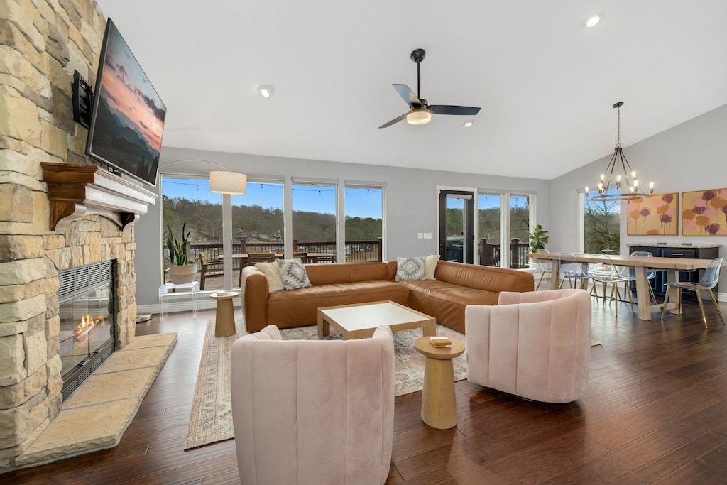 Enjoy two living areas with tons of cozy seating, a fully stocked kitchen, a ping pong table, and large windows with sweeping views of the Ozark Mountains and the lake.