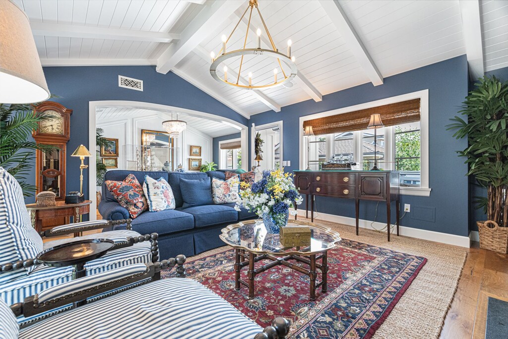 An elevated yet inviting living space adorned with rich textures, vaulted ceilings, and refined coastal décor