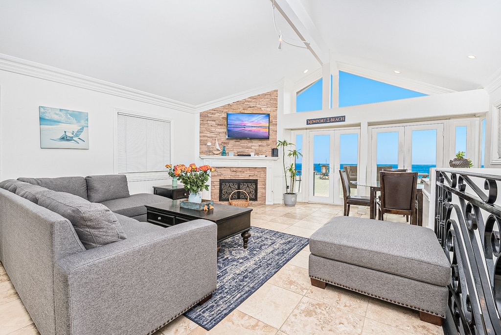 One of two living rooms in the rental, this second level living area includes a large sofa, cable TV, dining table for four, and French doors that lead to your beachfront patio.