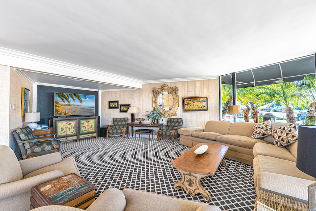 Pictured here is the main living area, with large sectional, additional seating, back-to-back gas fireplace, TV and sound system, and sliding doors out to the front patio.