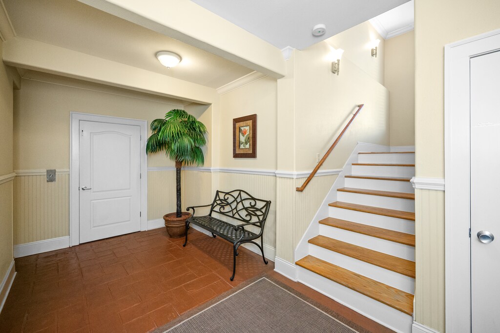 The entrance/ground floor has elevator access and stairs up to the main floor