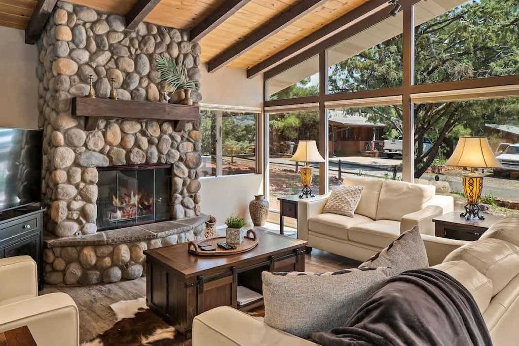 Living area complete with tv and shades for privacy and darkness. 