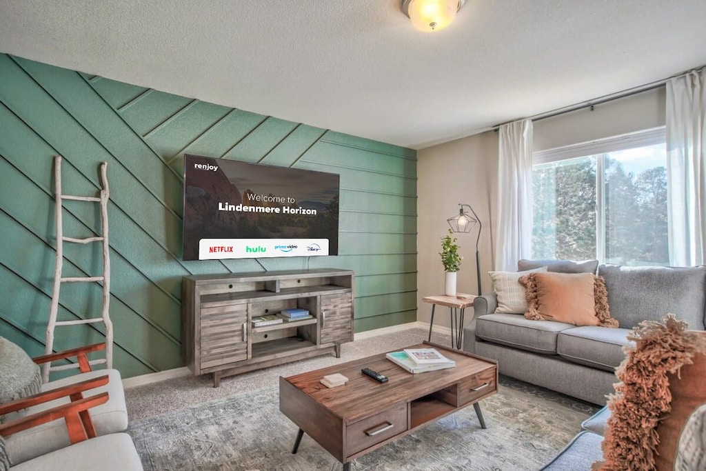 Welcome to our inviting living room! Sink into our plush couches, equipped with a Smart TV for your entertainment