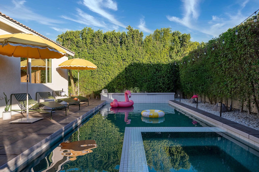 Pool and hot tub with sun loungers