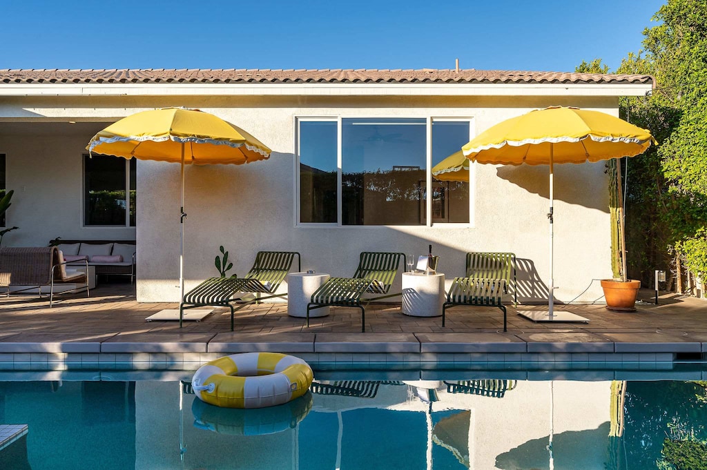 Pool and hot tub with sun loungers
