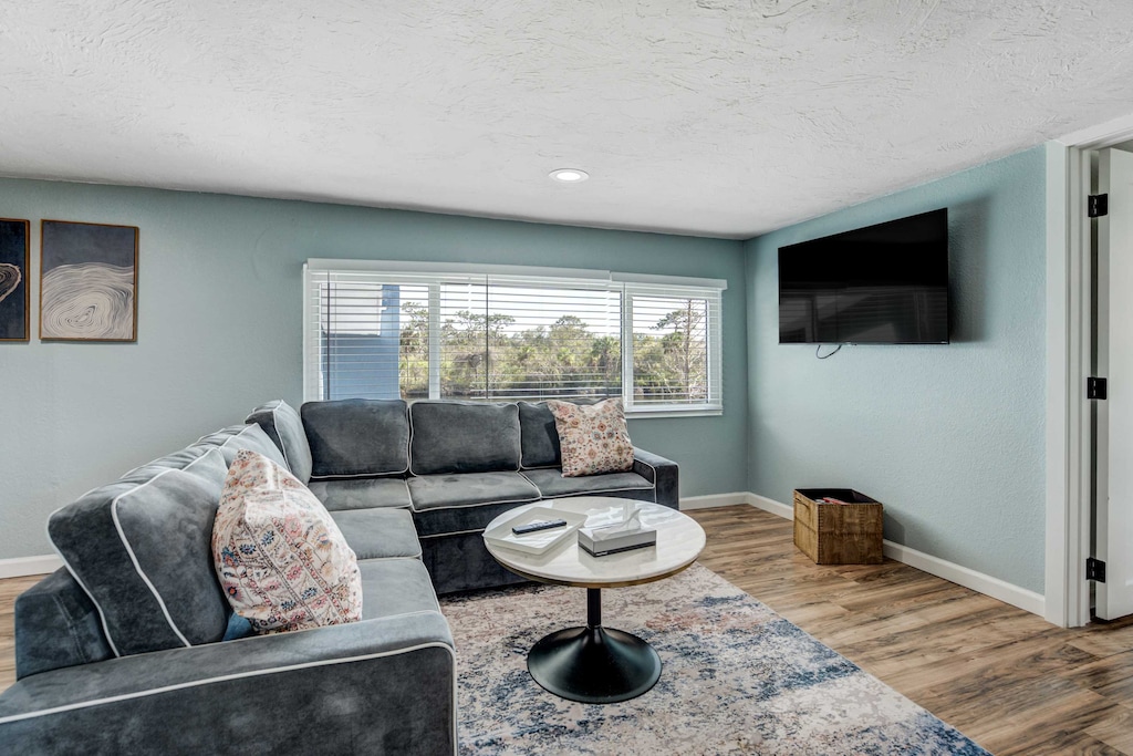 Relax in the cozy living area in our upstairs unit, featuring plush seating, a Smart TV, and large windows that bring in natural light.





