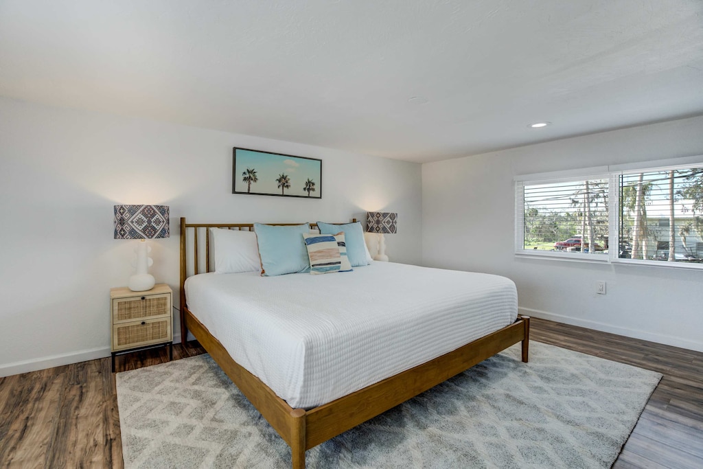 Drift into comfort in the spacious king bedroom, featuring soft linens, stylish decor, and plenty of natural light for a restful retreat.





