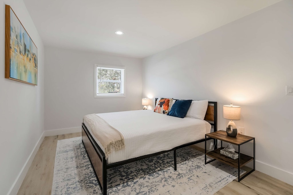Unwind in this peaceful bedroom featuring a comfortable bed, stylish decor, and soft lighting for a restful night’s sleep.





