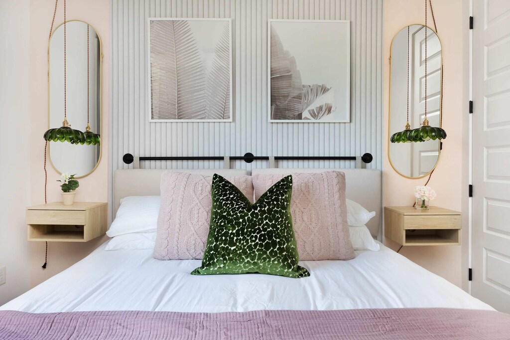 Spacious bedroom with a king bed, walk-in closet, and dedicated workspace. Features an en-suite bathroom with a shower and dual access from the bedroom and kitchen