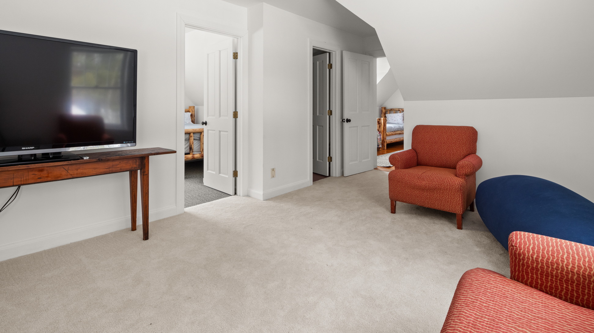 - Upstairs lounge with seating area for group relaxation time   - Open floor design connects bedrooms and provides easy flow   - Comfortable retreat with soft carpet for cozy evenings