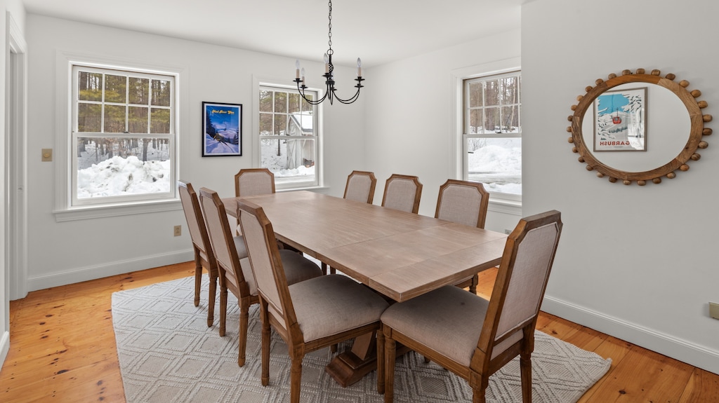 - Dining room with long wooden table for eight   - Bright windows create an inviting atmosphere   - Perfect space for family meals and gatherings