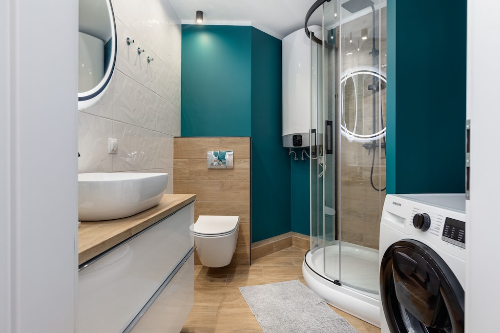 A compact bathroom with a corner shower, offering a clean and functional design.

