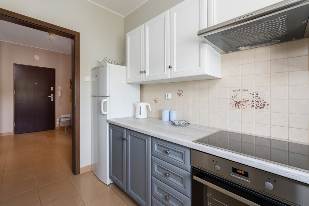 Kitchen with plenty of kitchen utensils and dishes. 