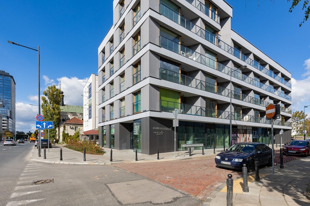A contemporary building exterior, showcasing clean lines and a modern design with balconies.
