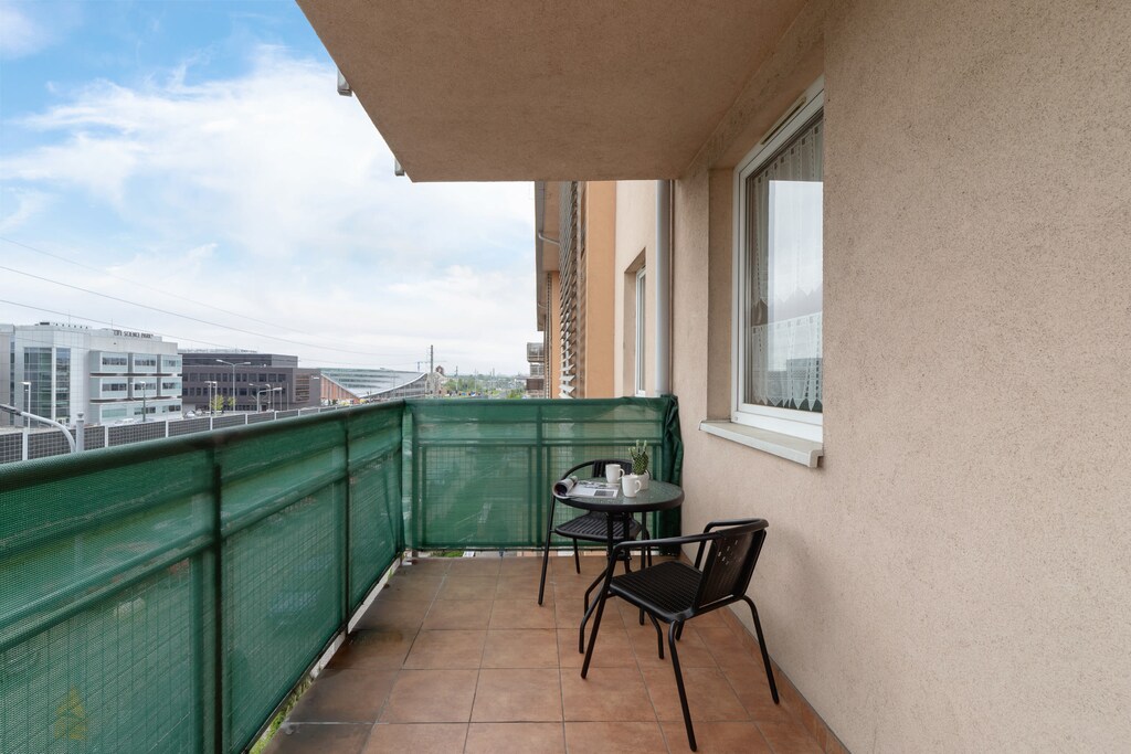 The balcony provides a perfect spot for enjoying the fresh air. 