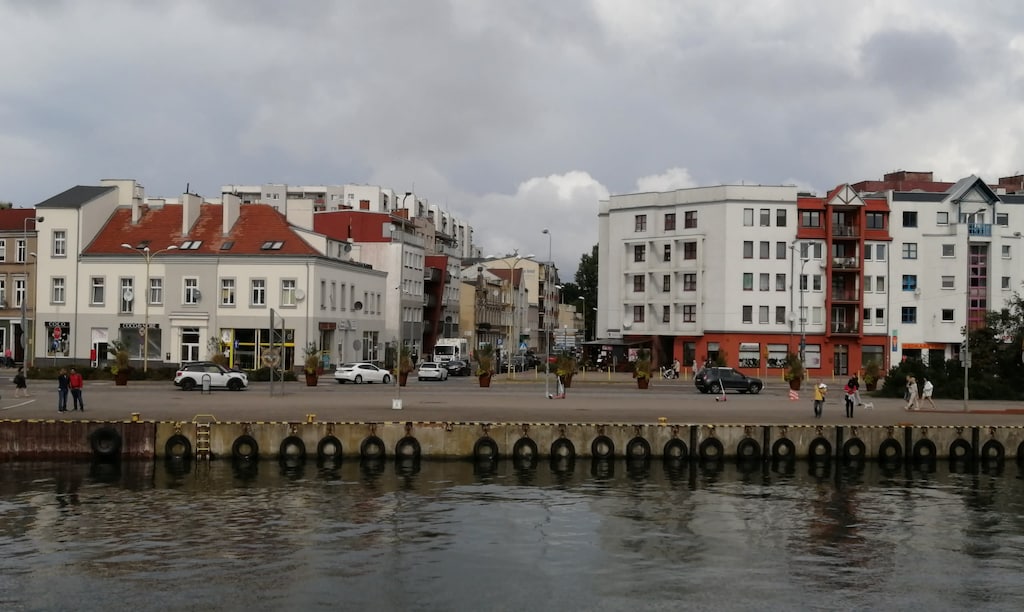 Scenic waterfront view showcasing charming architecture and serene surroundings.
