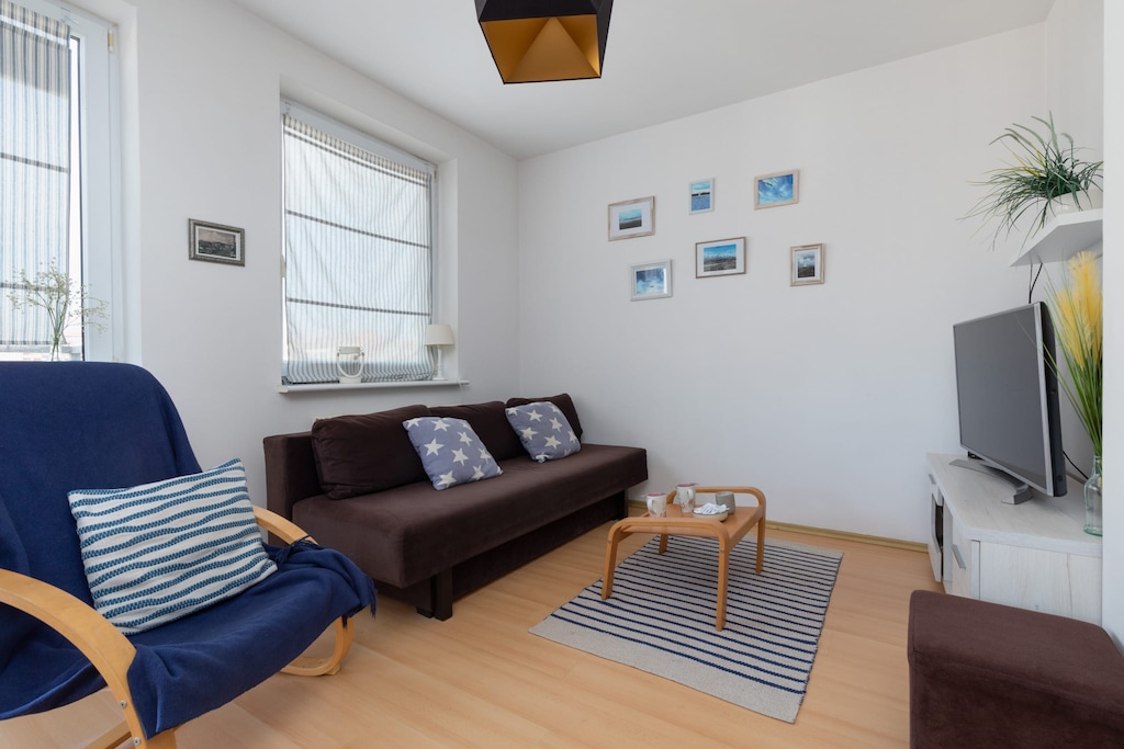 Bright and airy living room with a comfortable sofa and modern furniture, perfect for relaxation.
