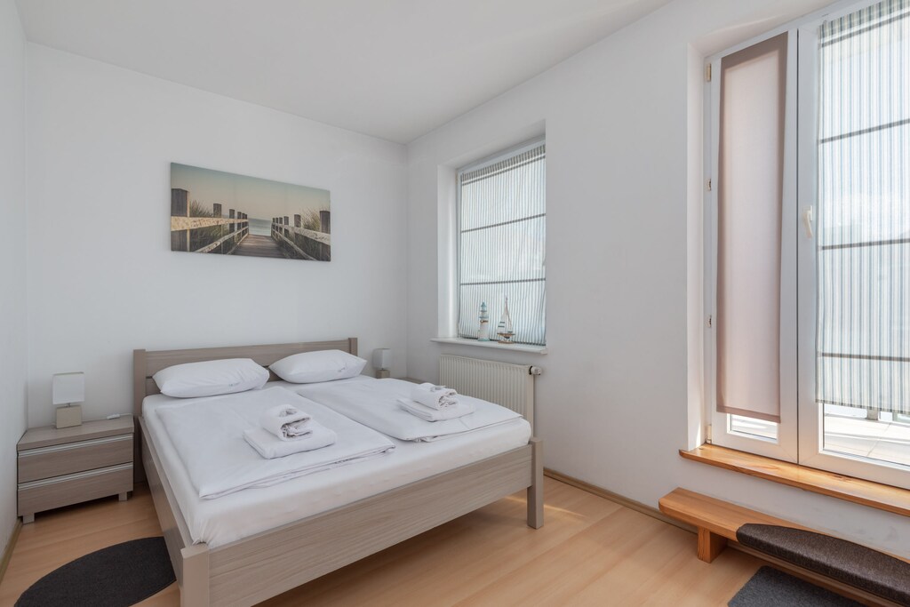 A cozy bedroom with a comfortable double bed and minimalistic decor, providing a peaceful retreat.
