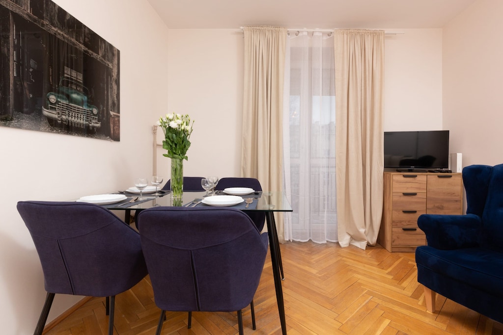 A dining area with a table and navy blue chairs, creating a stylish ambiance.
