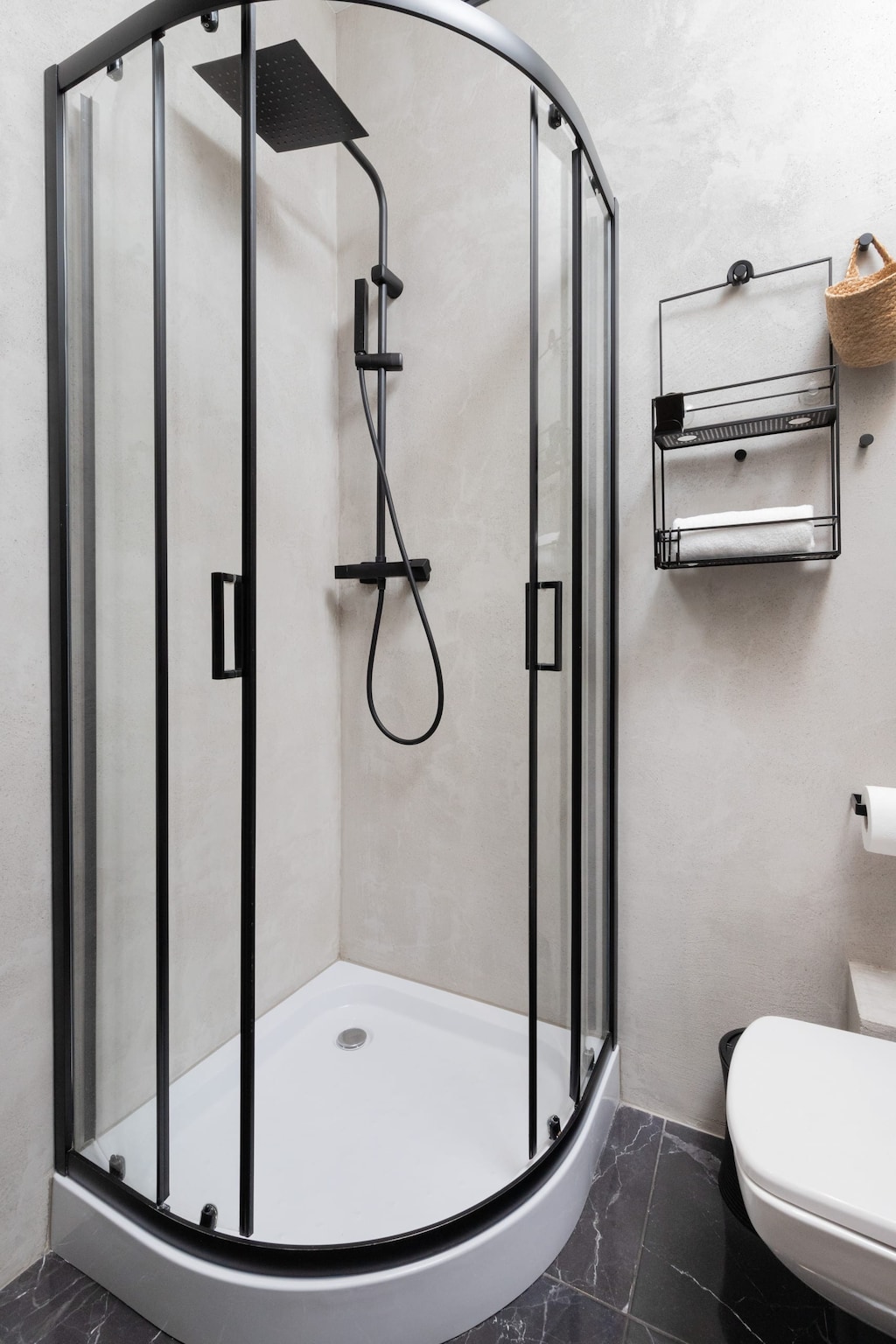 Bright bathroom with washing machine and shower cabin. 