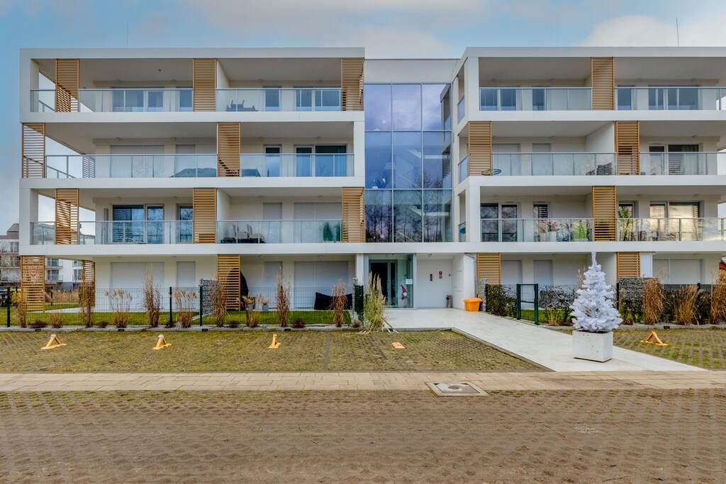 View from the street of a modern investment with apartments with balconies.