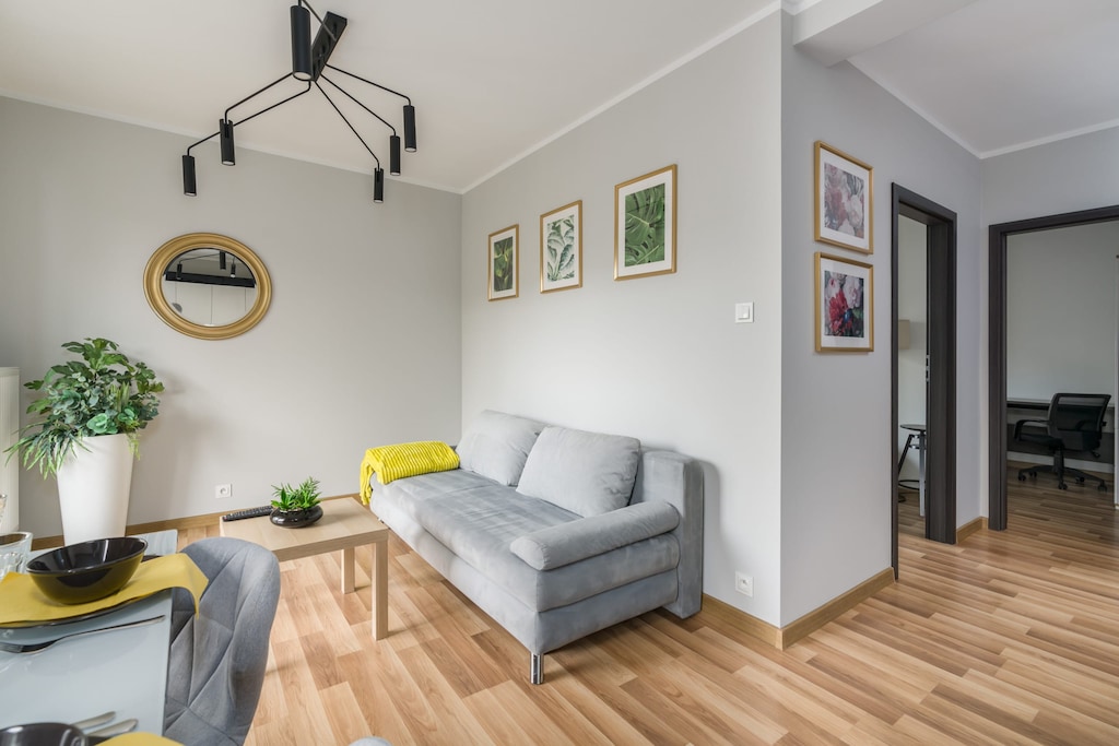 Relax in the stylish living room with a comfortable sofa and modern decor.