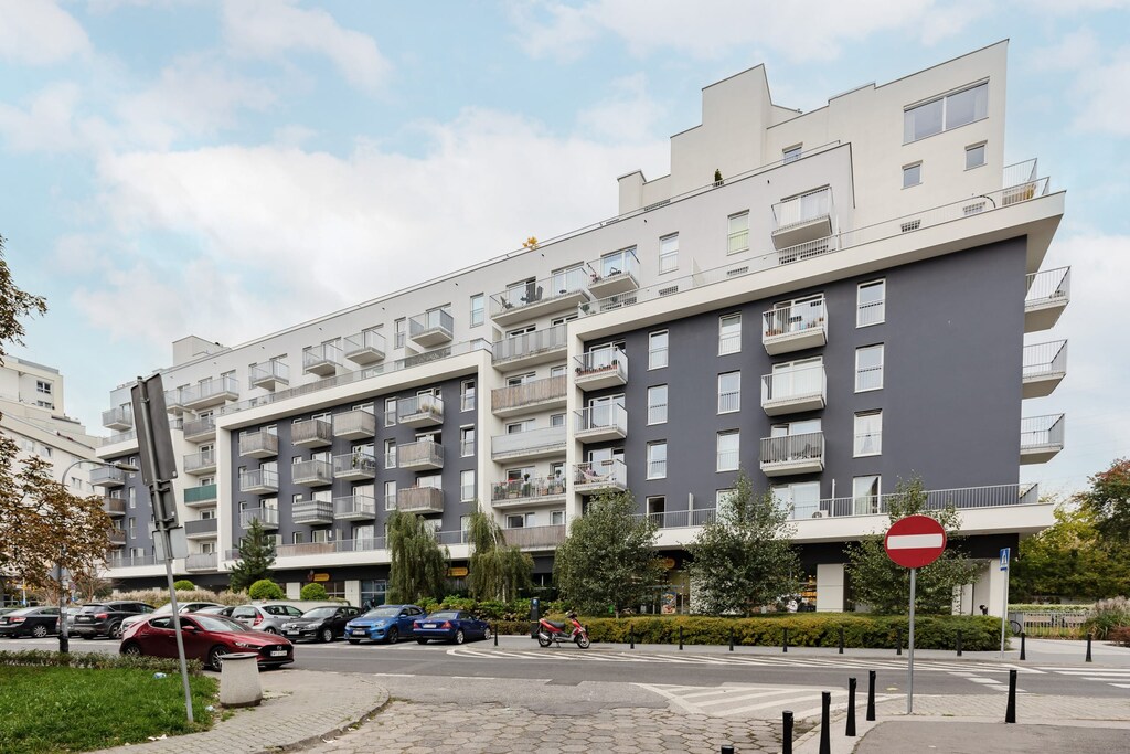 A view of a contemporary apartment complex with clean architectural lines and landscaped surroundings.