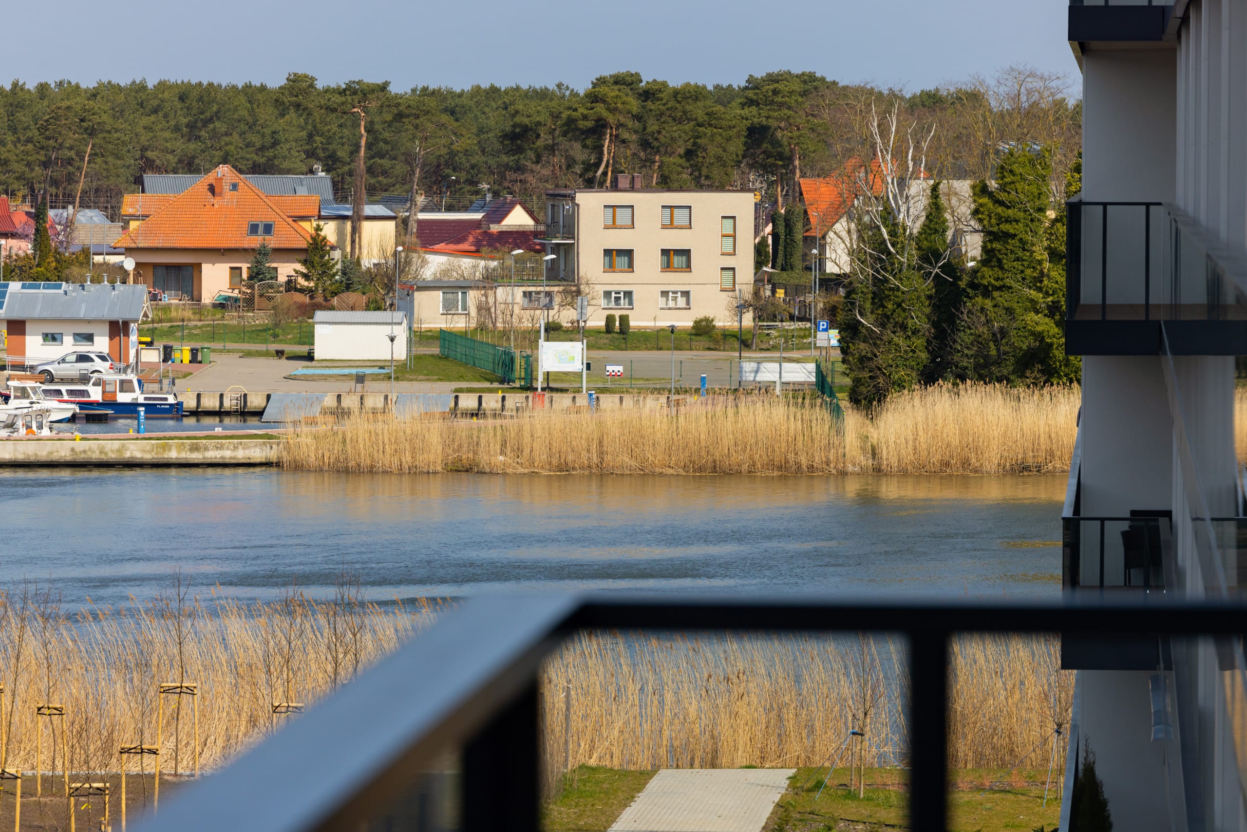 A picturesque view of the nearby marina and waterfront, visible from the balcony.
