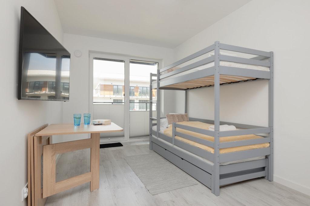 Spacious bedroom with a metal bunk bed, perfect for families with children.
