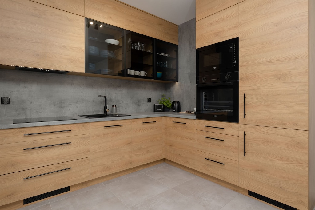 Kitchen with modern wooden cabinets and high-end appliances.
