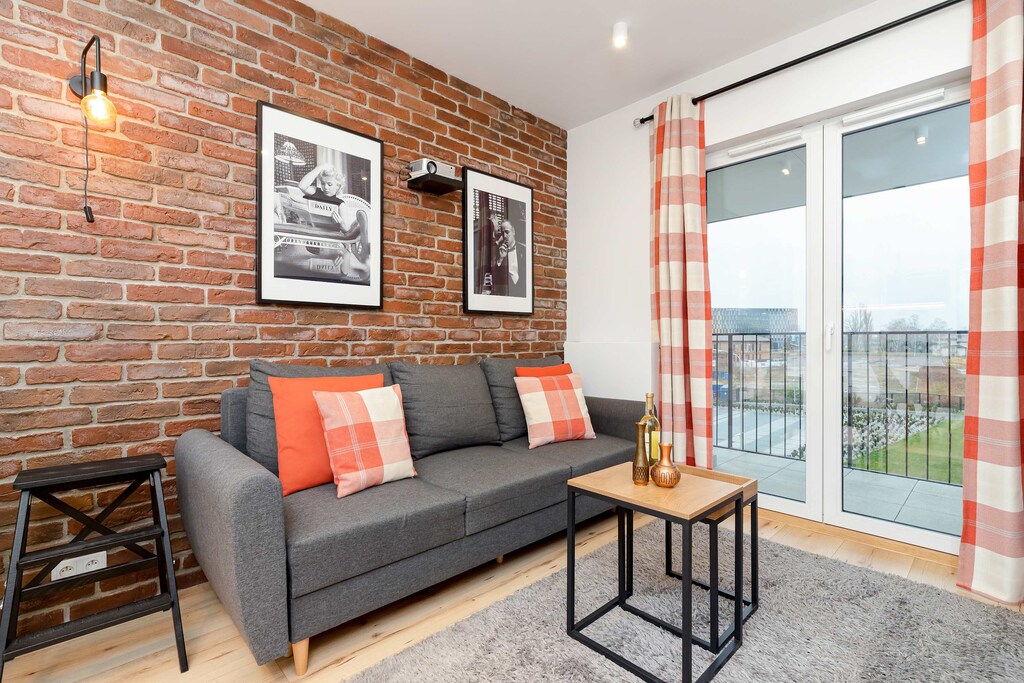 Cozy living room with double sofa bed, TV and access to the balcony.