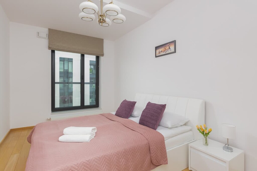 The cosy bedroom features a luxurious double bed and ample storage.