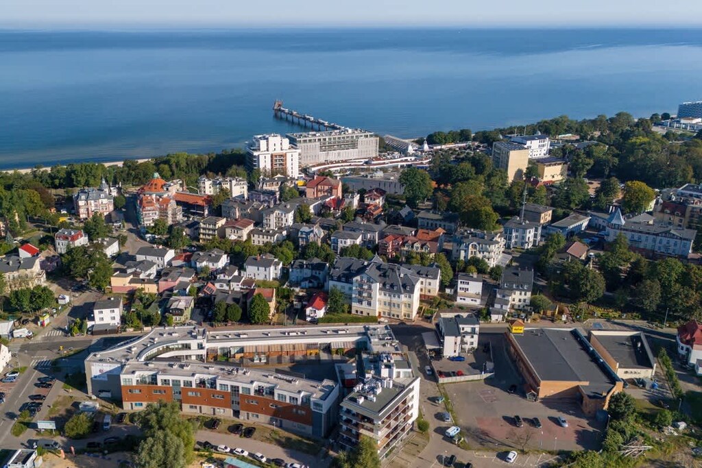A stunning aerial view of the neighborhood and nearby seaside, highlighting the vibrant coastal setting.

