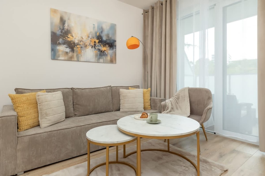 Living room with a comfortable sofa bed, Smart TV and access to balcony.