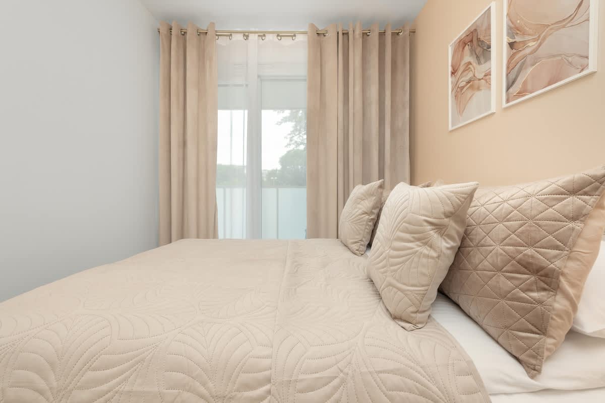 Bedroom with a comfortable double bed and access to balcony.