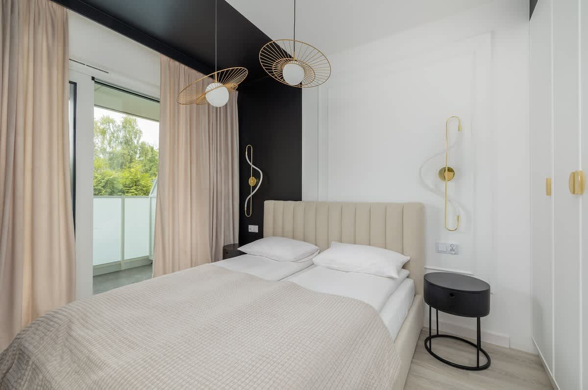 The cosy bedroom features a luxurious double bed and ample storage.