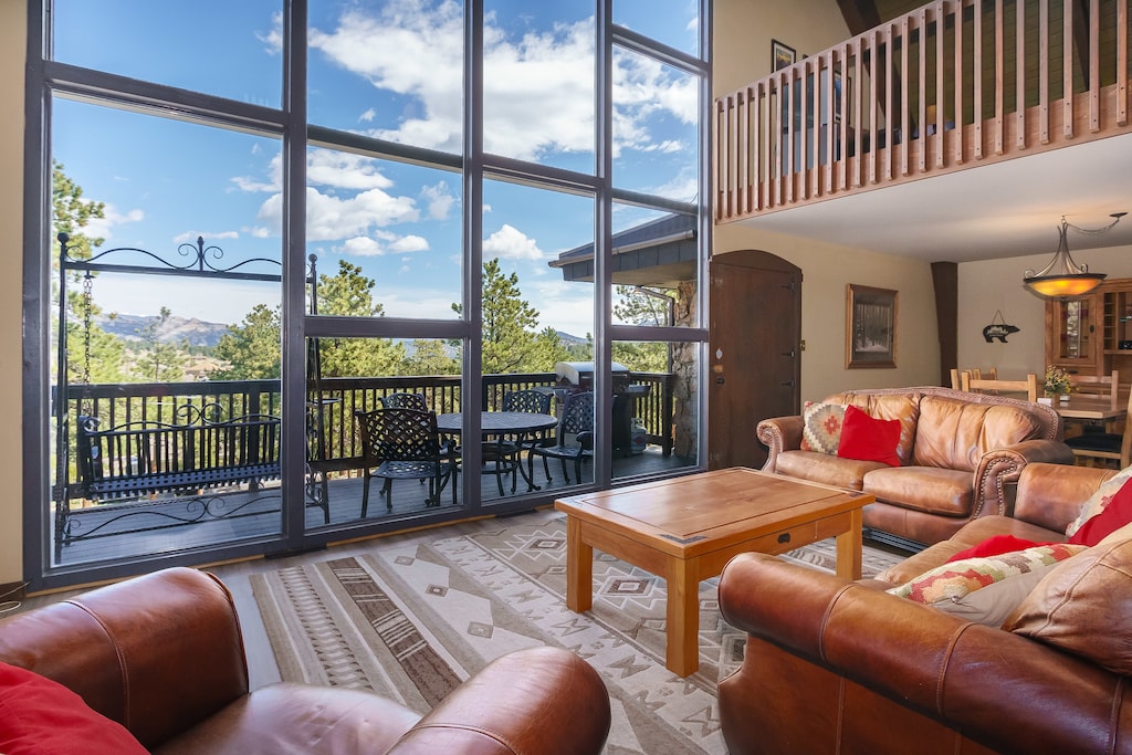 Open concept floor plan with cathedral ceiling and floor to ceiling windows. 