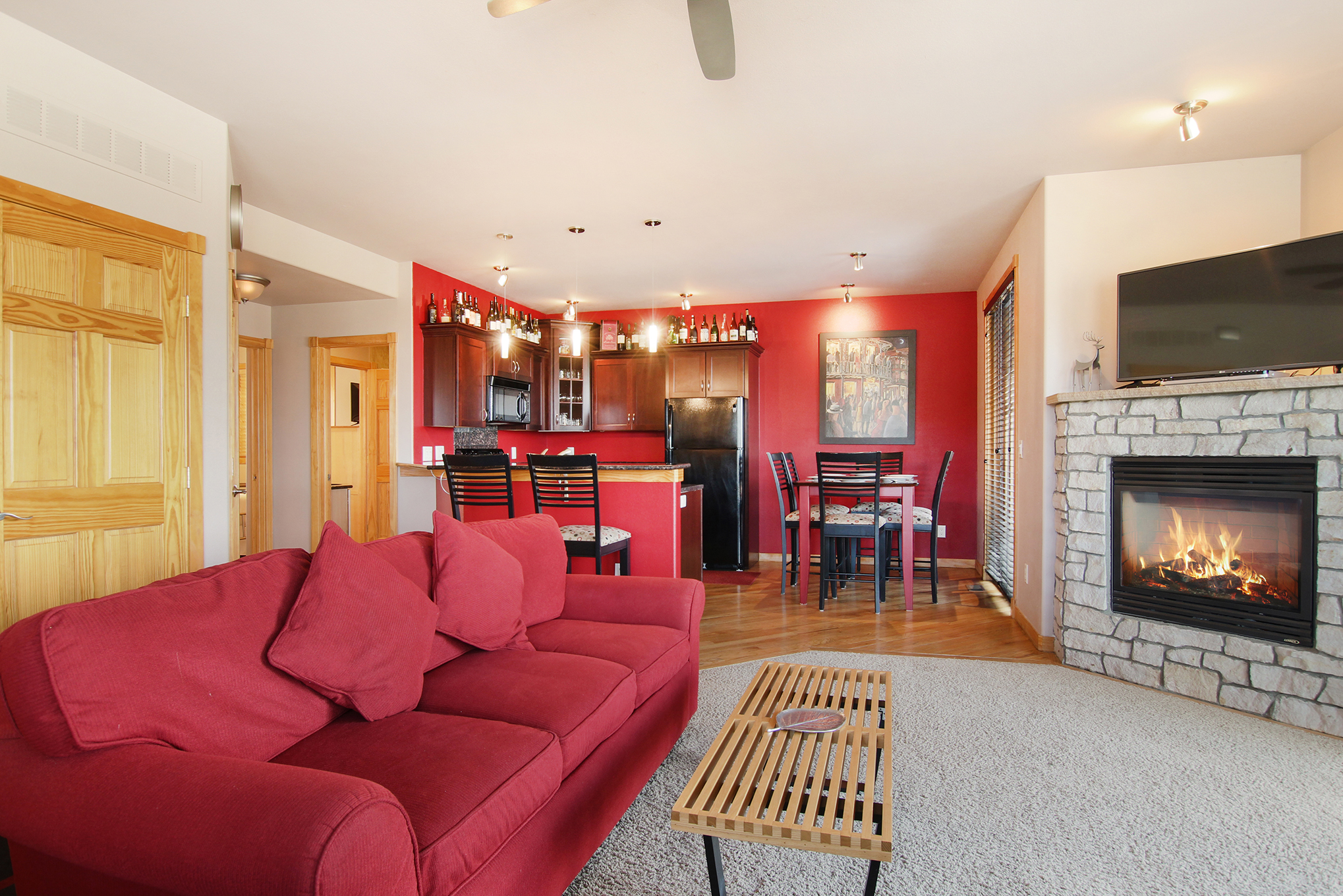 Comfortable queen sleeper sofa across from gas fireplace in the main living area.