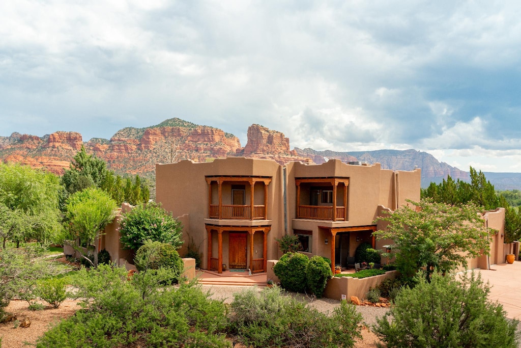This spectacular Santa Fe Style Hacienda is a sprawling two story home with amazing views of the red rocks of Sedona.