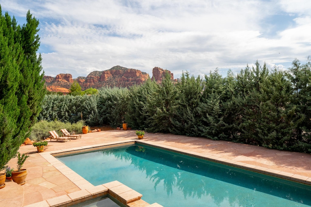 Escape the Desert sun and cool off in this Beautiful heatable swimming pool at Hot Tub is private with lush landscape all around.
