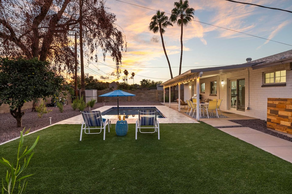 Private backyard, with a heated pool, covered patio and mountain views.