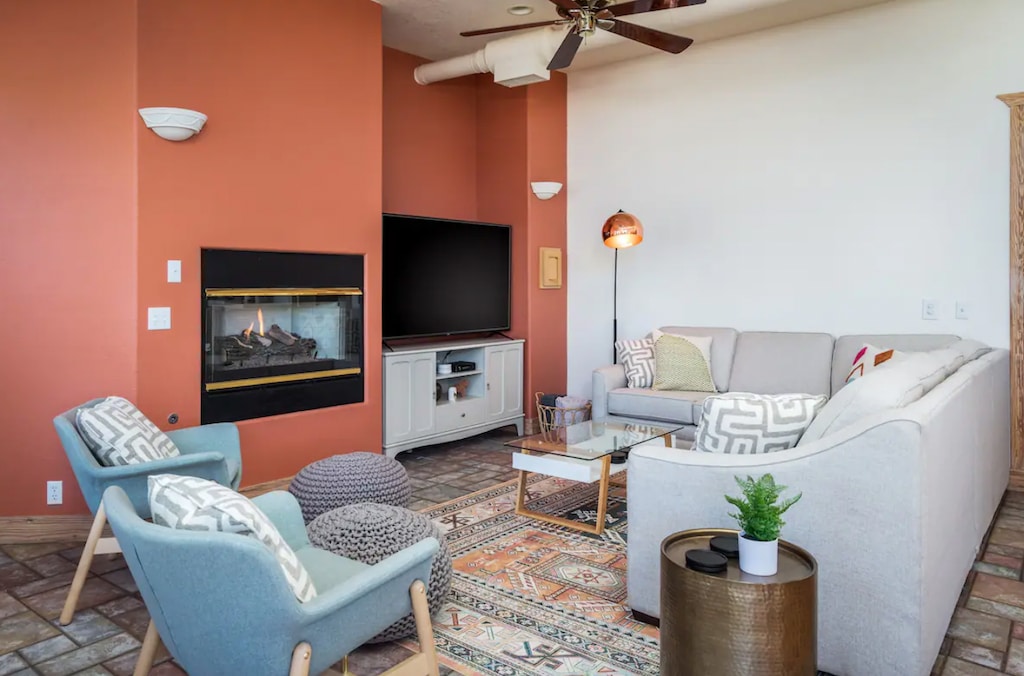 Living Room with sectional couch, Smart TV, and gas fireplace.