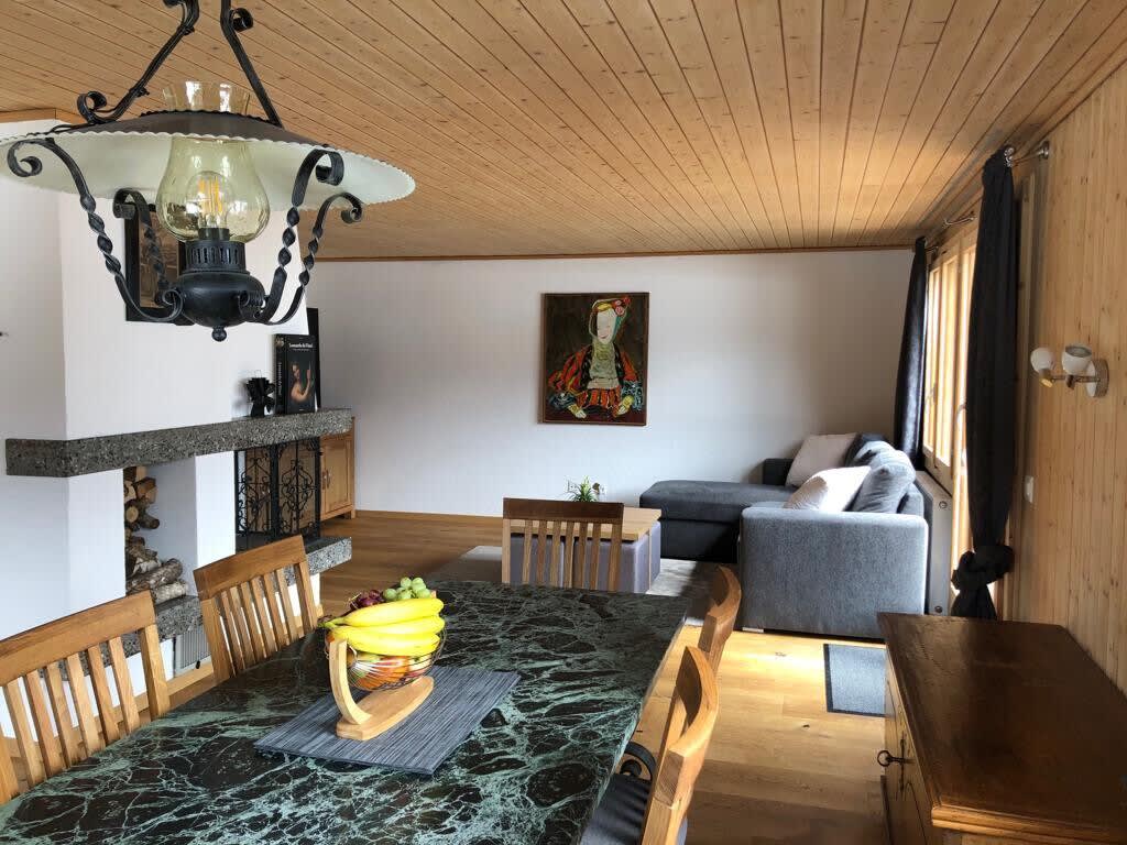 the beautiful living room dinning table and sitting area by the warm fire place 