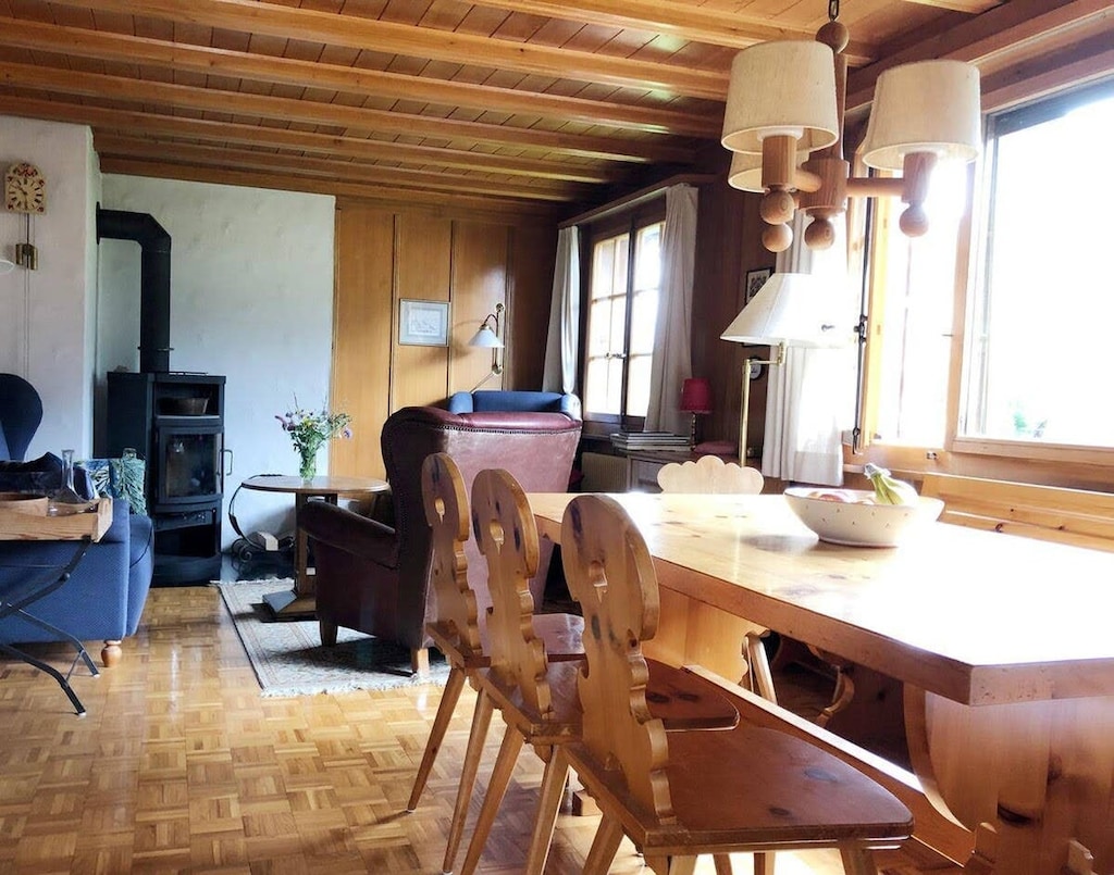 The dining table and the living room sitting area are in front of the fireplace.