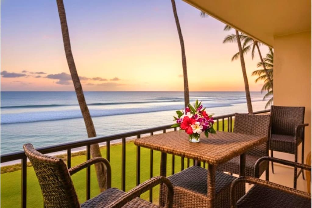Oceanfront lanai with a dining table for four, ideal for sunset dinners with uninterrupted views of the Pacific.
