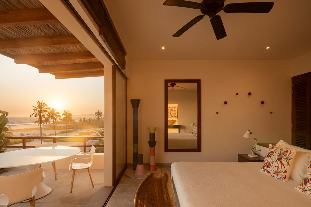 Wake up to serene ocean breezes in this elegantly designed bedroom with direct access to a private terrace.