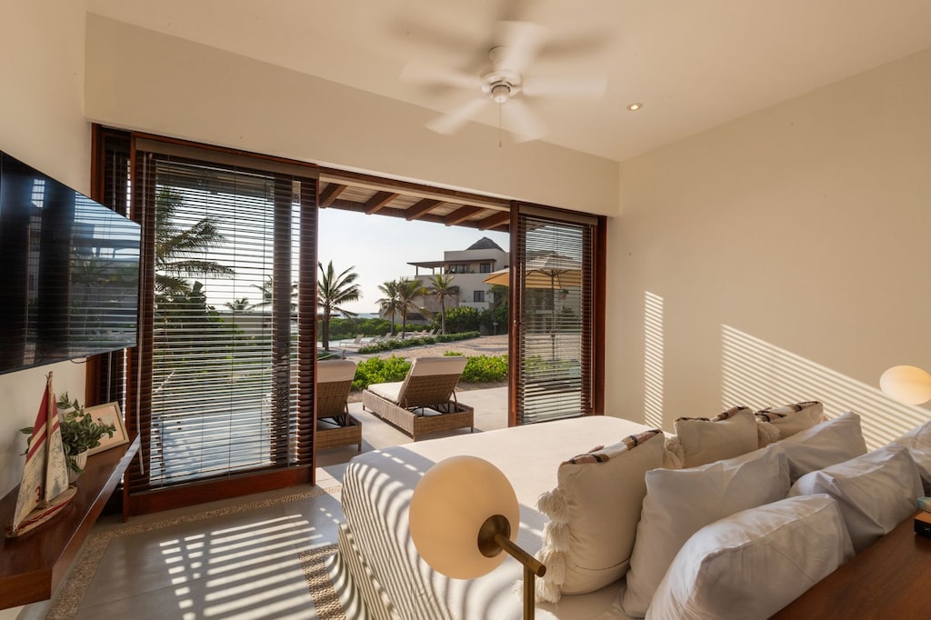 Wake up to breathtaking views in this charming bedroom with warm natural lighting and a private terrace